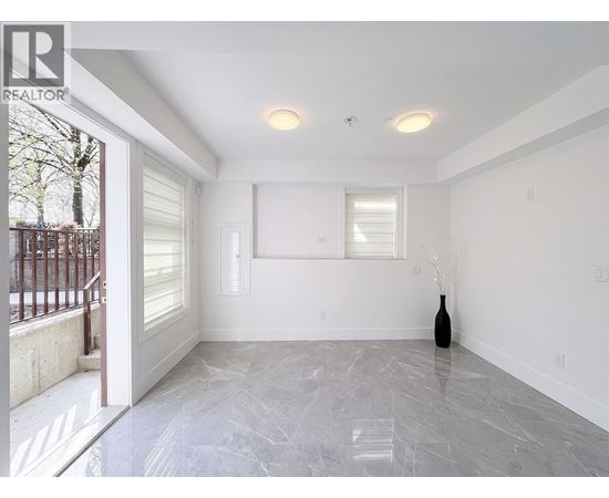 A room with a marble floor and a vase on the floor.