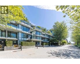 A sunny day at a modern apartment complex with a clear blue sky.