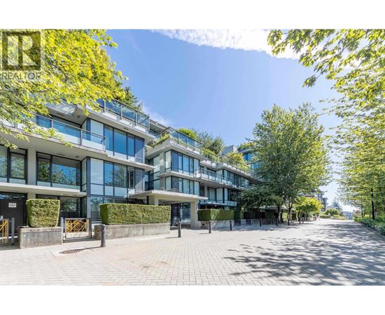 A sunny day at a modern apartment complex with a clear blue sky.