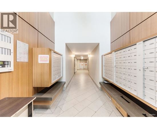 A hallway with a Realtor sign on the wall.