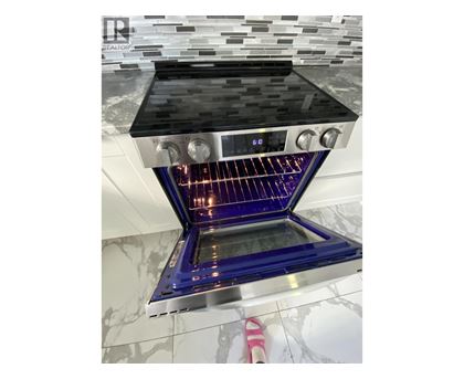A modern kitchen with a stove top oven.
