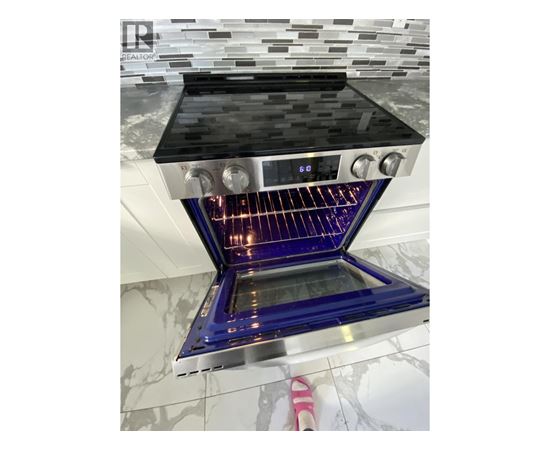 A modern kitchen with a stove top oven.