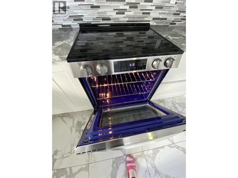 A modern kitchen with a stove top oven.