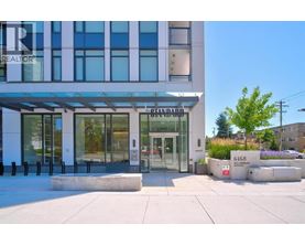 A modern building with a glass entrance and a sign that reads "REALTOR".