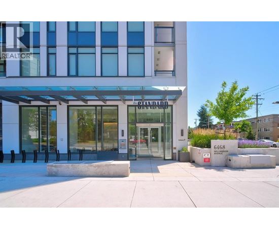 A modern building with a glass entrance and a sign that reads "REALTOR".