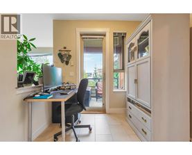 A home office with a desk, chair, and computer.
