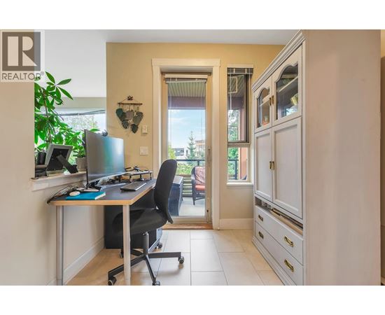 A home office with a desk, chair, and computer.