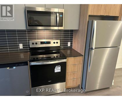 A kitchen with EXP REALTY Brokerage written on the wall.