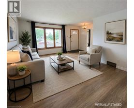 A living room with a couch, chair, and coffee table.