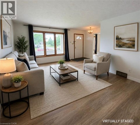 A living room with a couch, chair, and coffee table.