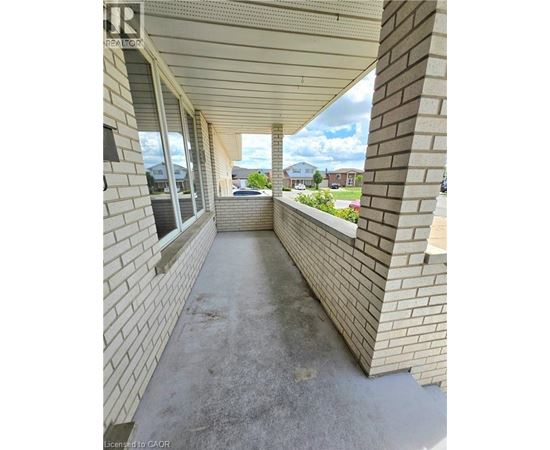A long concrete walkway between two brick walls.