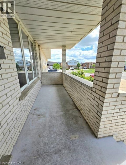 A long concrete walkway between two brick walls.