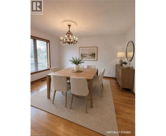 A dining room with a wooden table and chairs.