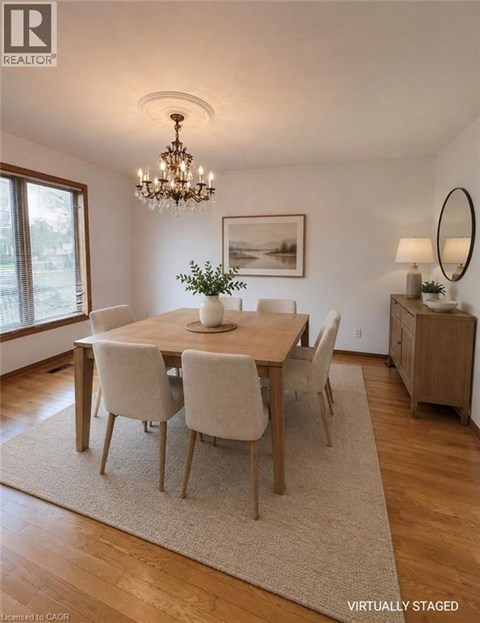 A dining room with a wooden table and chairs.