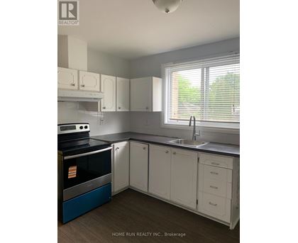 A kitchen with white cabinets and a blue oven.