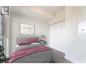 A bedroom with a bed, a nightstand, and a painting on the wall.