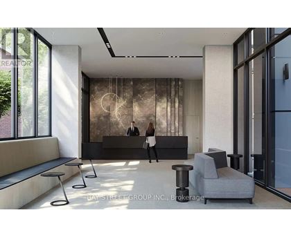 A brokerage office with a reception desk and two people standing behind it.