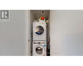 A white washing machine is in a small space.