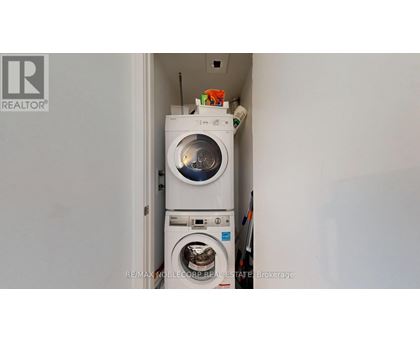 A white washing machine is in a small space.