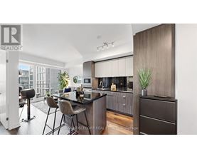 A modern kitchen with dark wood cabinets and a bar area.