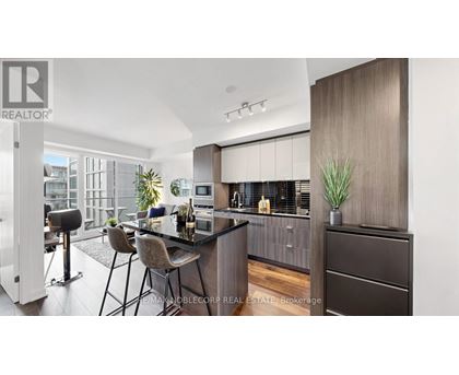 A modern kitchen with dark wood cabinets and a bar area.