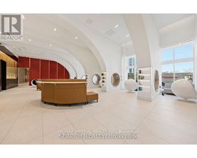 A modern office space with a curved wall and a reception desk.
