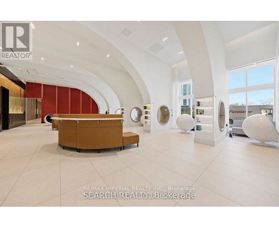 A modern office space with a curved wall and a reception desk.