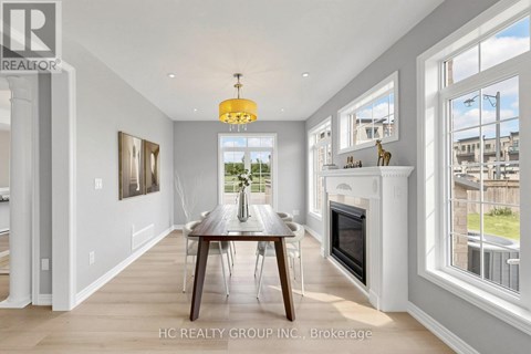 A modern dining room with a wooden table and chairs.