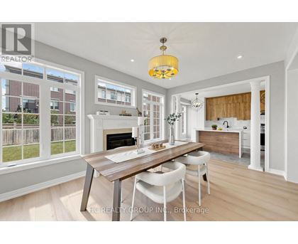 A modern kitchen with a dining table and chairs.