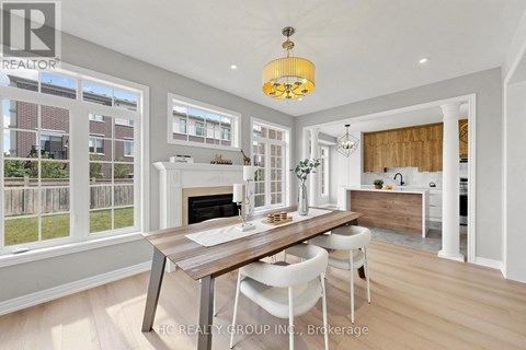 A modern kitchen with a dining table and chairs.