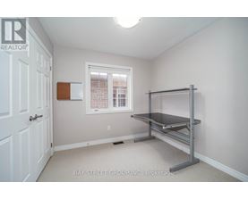 A bedroom with a bed frame and a window.