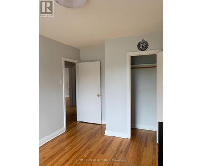 A room with a wooden floor and two white doors.