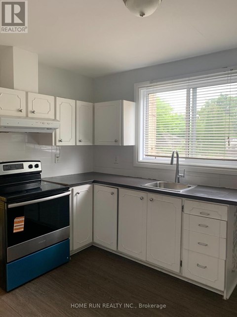 A kitchen with white cabinets and a blue oven.