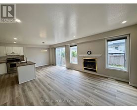 A spacious living room with a fireplace and sliding glass doors.