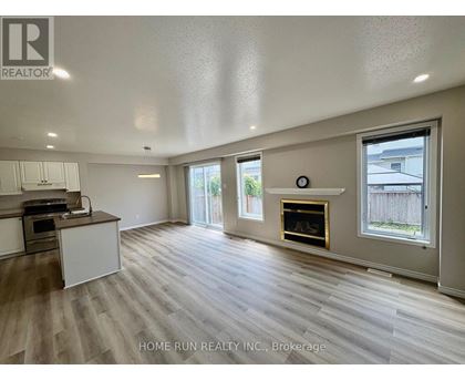 A spacious living room with a fireplace and sliding glass doors.