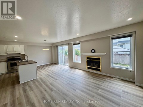 A spacious living room with a fireplace and sliding glass doors.