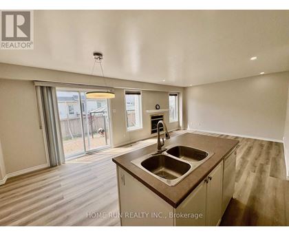 A kitchen with a sink and a window.