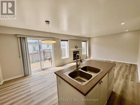 A kitchen with a sink and a window.