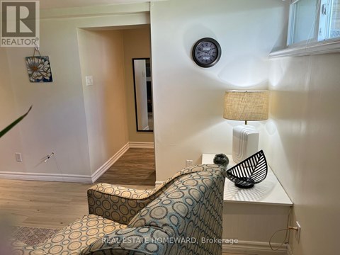 A living room with a couch and a lamp.
