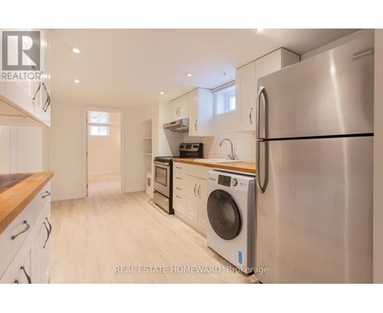 A modern kitchen with a stainless steel refrigerator and wooden countertops.