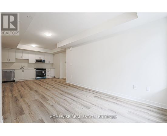 A real estate brokerage image of a home interior with wood flooring and white walls.