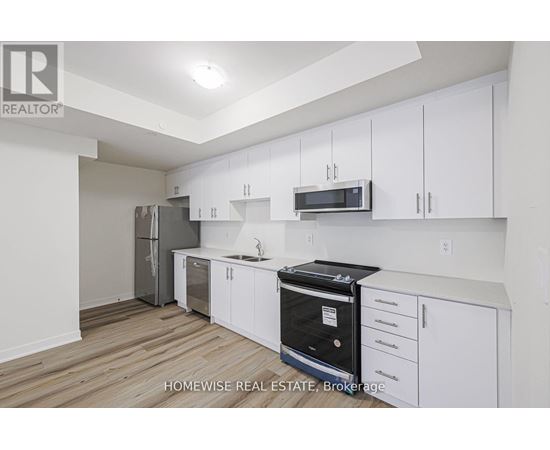 A kitchen with white cabinets and a black oven.