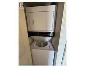 A white washing machine in a small space.