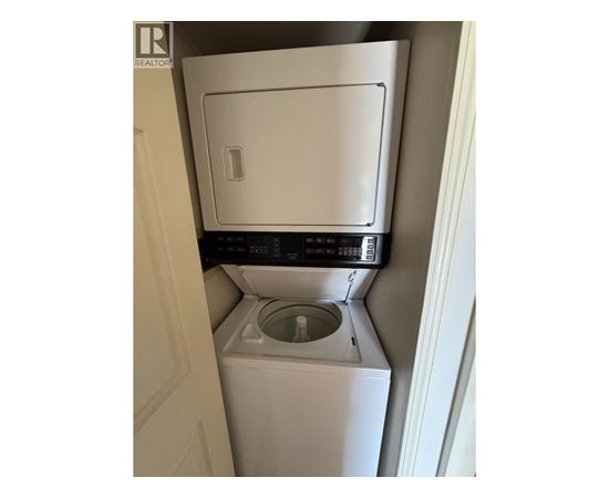 A white washing machine in a small space.