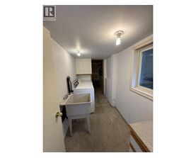 A bathroom with a sink and a window.