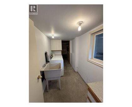 A bathroom with a sink and a window.