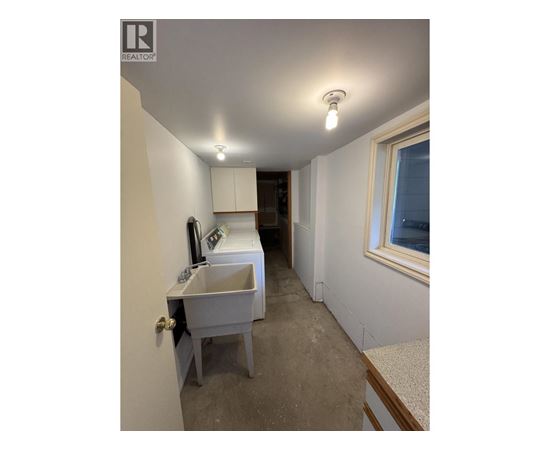 A bathroom with a sink and a window.