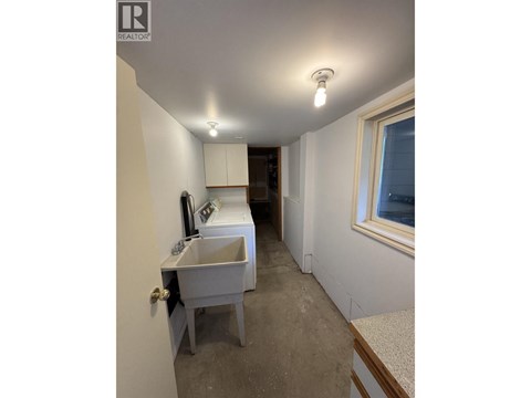 A bathroom with a sink and a window.