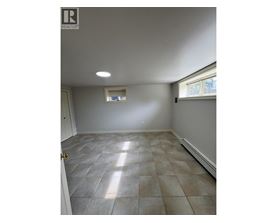 A room with tile flooring and a window.
