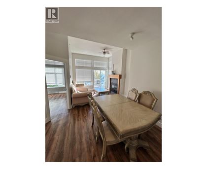 A dining room with a table and chairs.